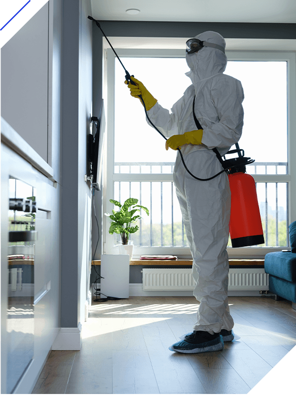 A man in a protective suit disinfects against a virus