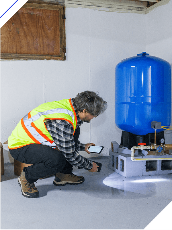 Broken water pressure tank in flooded basement