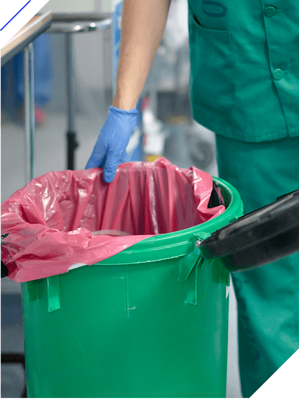 Nurse disposing of medical waste in hospital setting